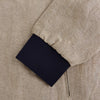View 4 of product A Fairway Sand Golf Jacket in Linen by Turnbull & Asser UK, crafted from lightweight herringbone linen, features a front zipper, a chest zip pocket, two side zip pockets, and dark navy cuffs, collar lining, and waistband. Shown on a plain white background.