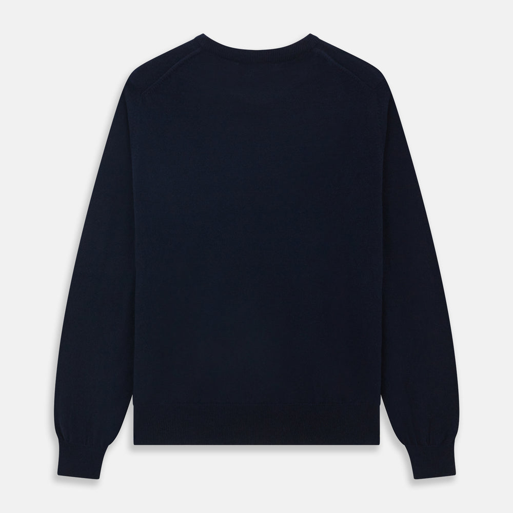A luxurious navy crew neck cashmere jumper by Turnbull & Asser is laid flat on a white background, evoking timeless Scottish cashmere craftsmanship.