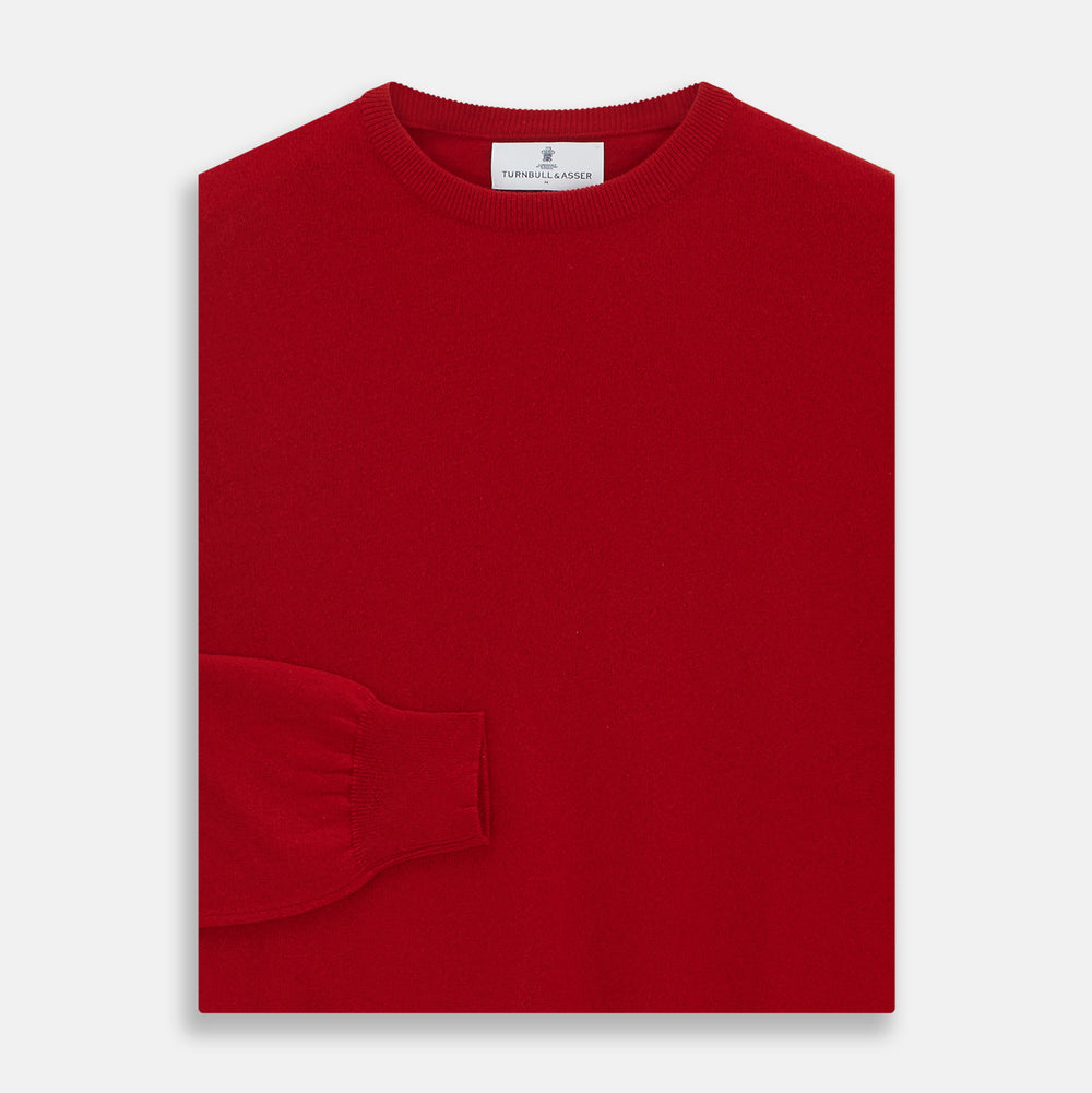 The Turnbull & Asser Deep Red Crew Neck Cashmere Jumper features long sleeves and a plain, solid hue—luxuriously soft and ideal for smart casual style. Displayed flat on a white background.