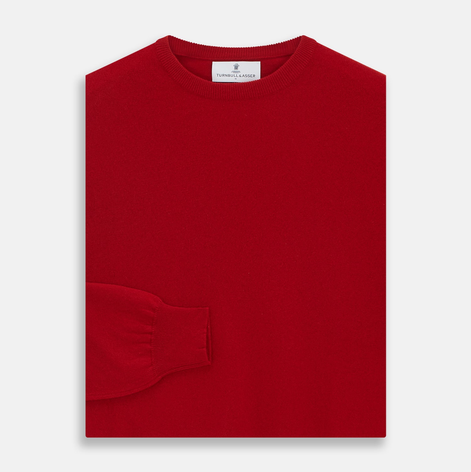 View 3 of product The Turnbull & Asser Deep Red Crew Neck Cashmere Jumper features long sleeves and a plain, solid hue—luxuriously soft and ideal for smart casual style. Displayed flat on a white background.