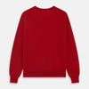 View 4 of product The Turnbull & Asser Deep Red Crew Neck Cashmere Jumper features long sleeves and a plain, solid hue—luxuriously soft and ideal for smart casual style. Displayed flat on a white background.