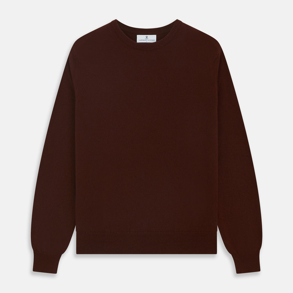 The Turnbull & Asser Port Cashmere Crew Neck Jumper, in dark brown, features a plain design with long sleeves and is shown laid flat on a white background.
