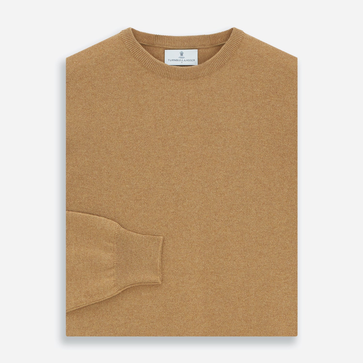 View 3 of product The Turnbull & Asser Camel Crew Neck Merino Wool Jumper is a classic, long-sleeve sweater in camel, laid flat on a white background. Featuring ribbed collar, cuffs, and hem, it’s an essential staple for every gentleman’s wardrobe.