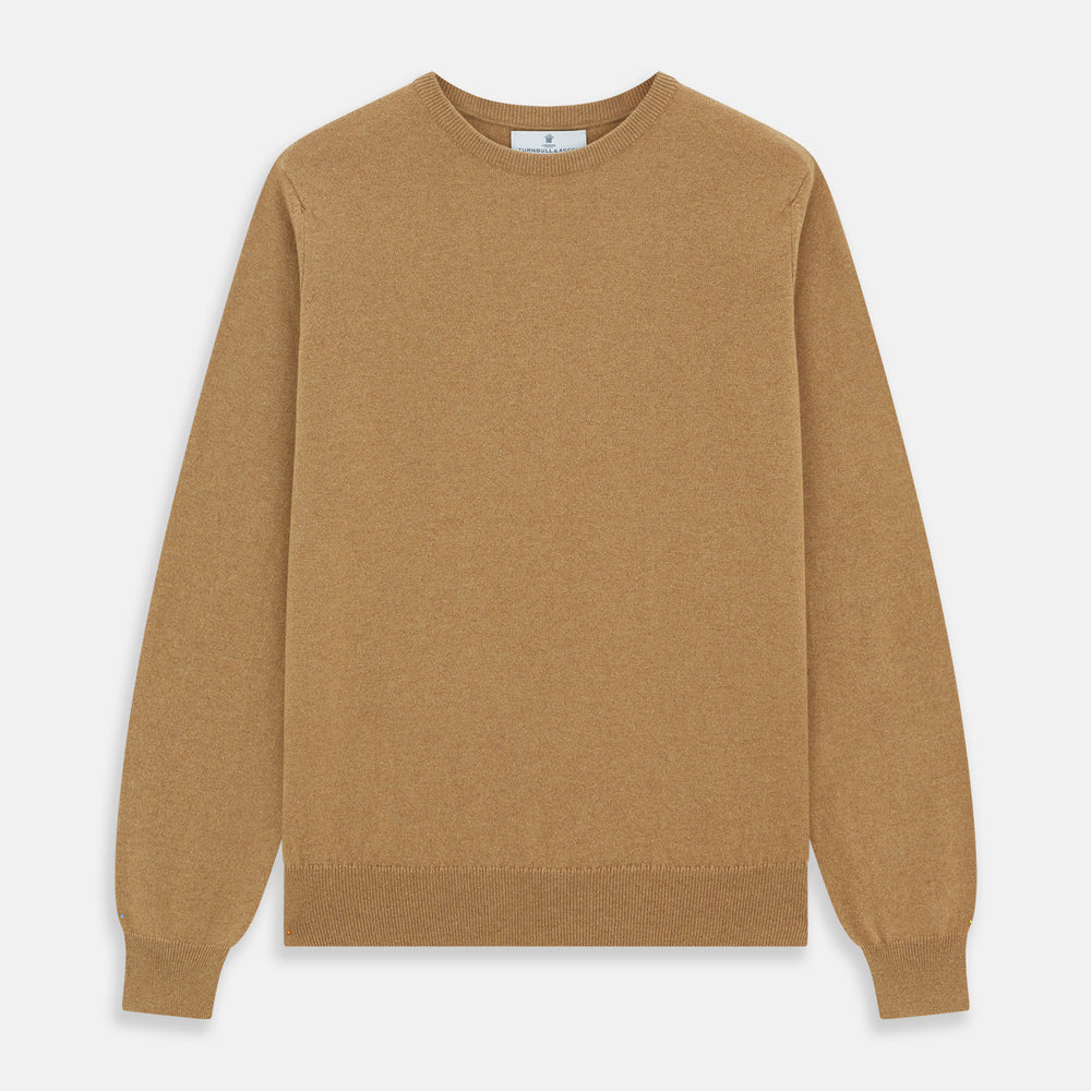 The Turnbull & Asser Camel Crew Neck Merino Wool Jumper is a classic, long-sleeve sweater in camel, laid flat on a white background. Featuring ribbed collar, cuffs, and hem, it’s an essential staple for every gentleman’s wardrobe.