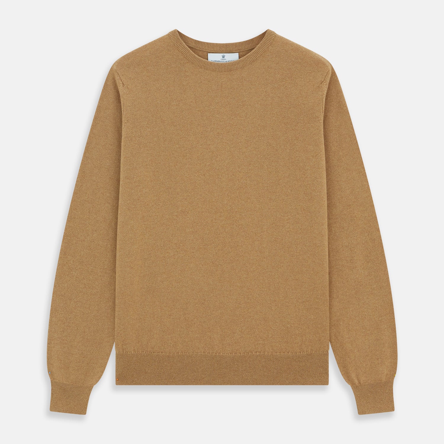 View 1 of product The Turnbull & Asser Camel Crew Neck Merino Wool Jumper is a classic, long-sleeve sweater in camel, laid flat on a white background. Featuring ribbed collar, cuffs, and hem, it’s an essential staple for every gentleman’s wardrobe.