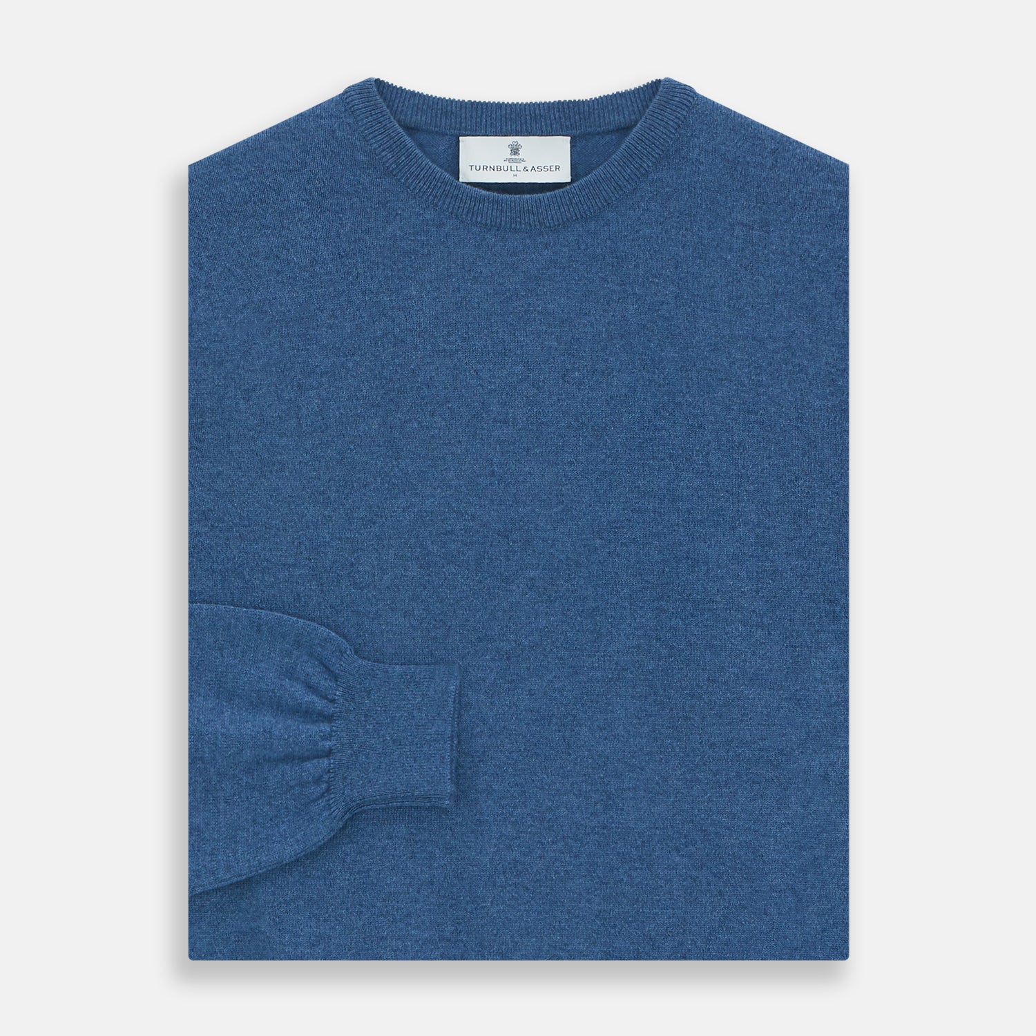 View 3 of product The Turnbull & Asser Blue Crew Neck Cashmere Jumper is laid flat on a white background, showcasing ribbed cuffs, hem, and neckline for an elegant, smart-casual style.