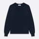 The Turnbull & Asser Navy V-Neck Cashmere Jumper, featuring long sleeves and ribbed cuffs and hem, is laid flat on a white background, showcasing its simple and classic design.