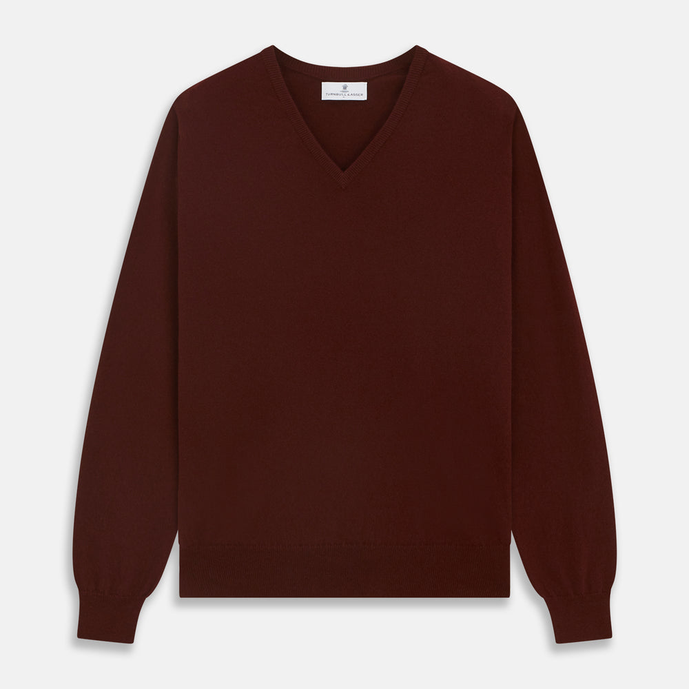 The Turnbull & Asser Port Cashmere V-Neck Jumper is a plain, long-sleeved burgundy sweater with a V-neck, shown flat on a white background.