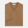 View 3 of product The Turnbull & Asser Natural V-Neck Cashmere Jumper, in camel, features long sleeves and ribbed cuffs, hem, and neckline. Crafted from Scottish cashmere, it’s laid flat on a white background for a refined smart casual look.