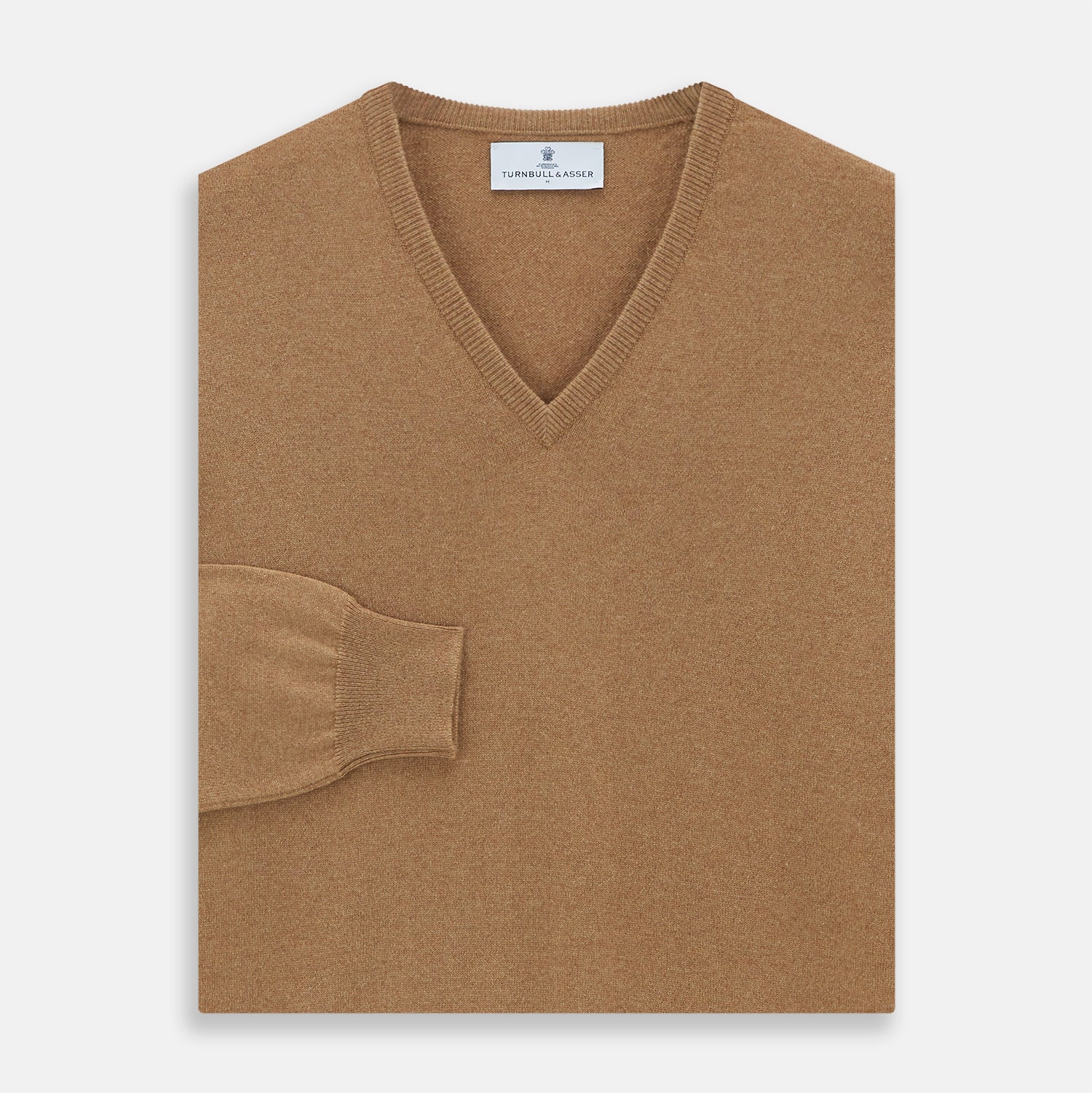View 3 of product The Turnbull & Asser Natural V-Neck Cashmere Jumper, in camel, features long sleeves and ribbed cuffs, hem, and neckline. Crafted from Scottish cashmere, it’s laid flat on a white background for a refined smart casual look.