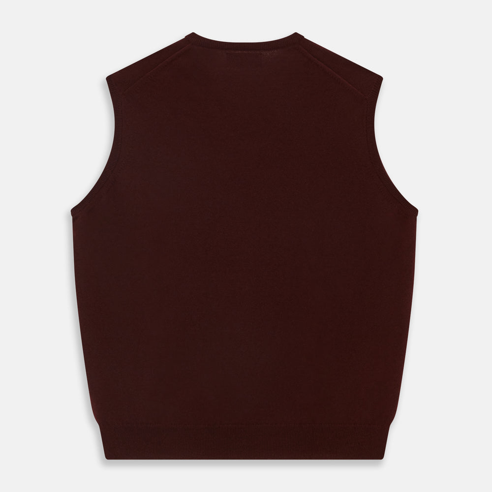 The Turnbull & Asser Port V-Neck Cashmere Slipover is a sleeveless, dark maroon vest with a simple design, shown laid flat on a white background—ideal for layering over a shirt or under a suit jacket.