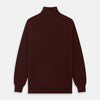 View 4 of product The Turnbull & Asser Port Cashmere Half-Zip Jumper is a dark maroon, long-sleeve style with a high collar, silver half-zip, and ribbed cuffs and hem, shown laid flat on a white background—ideal for layering.
