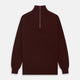 The Turnbull & Asser Port Cashmere Half-Zip Jumper is a dark maroon, long-sleeve style with a high collar, silver half-zip, and ribbed cuffs and hem, shown laid flat on a white background—ideal for layering.