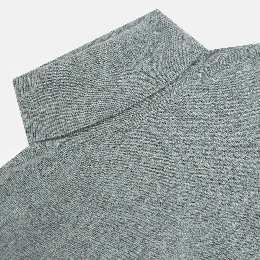 The Turnbull & Asser Kylian Flannel Grey Roll Neck Jumper features long sleeves, ribbed cuffs and hem—ideal for autumn layering. Laid flat on a white background.