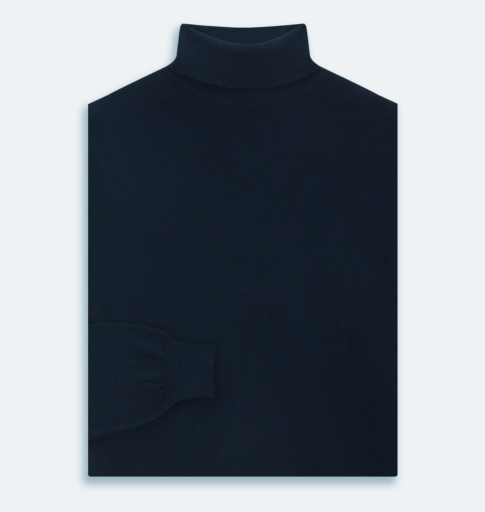 The Turnbull & Asser Navy Cashmere Roll Neck Jumper, with ribbed cuffs and hem, is a timeless autumn essential. Shown laid flat on a white background, this plain long-sleeved sweater offers classic style and comfort.