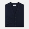 View 3 of product The Navy Cashmere Cardigan by Turnbull & Asser features long sleeves, a V-neckline, button-down front, two front pockets, and ribbed trims, crafted from 21GG cashmere in navy blue and shown laid flat on a white background.