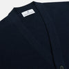 View 2 of product The Navy Cashmere Cardigan by Turnbull & Asser features long sleeves, a V-neckline, button-down front, two front pockets, and ribbed trims, crafted from 21GG cashmere in navy blue and shown laid flat on a white background.