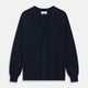 The Navy Cashmere Cardigan by Turnbull & Asser features long sleeves, a V-neckline, button-down front, two front pockets, and ribbed trims, crafted from 21GG cashmere in navy blue and shown laid flat on a white background.
