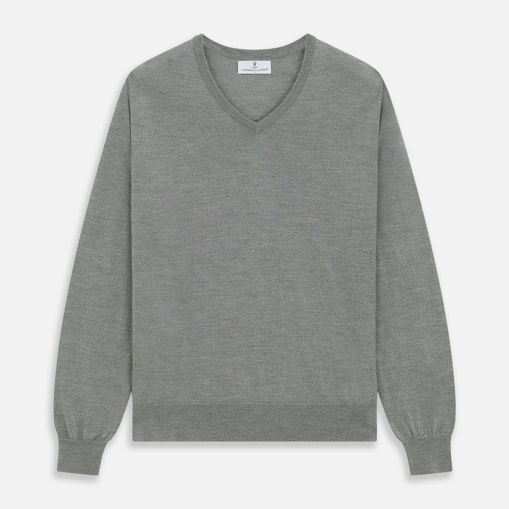 The Grey V-Neck Merino Wool Jumper by Turnbull & Asser features long sleeves with ribbed cuffs and hem, making it a versatile wardrobe essential for any gentleman. Shown here in classic light grey on a white background.