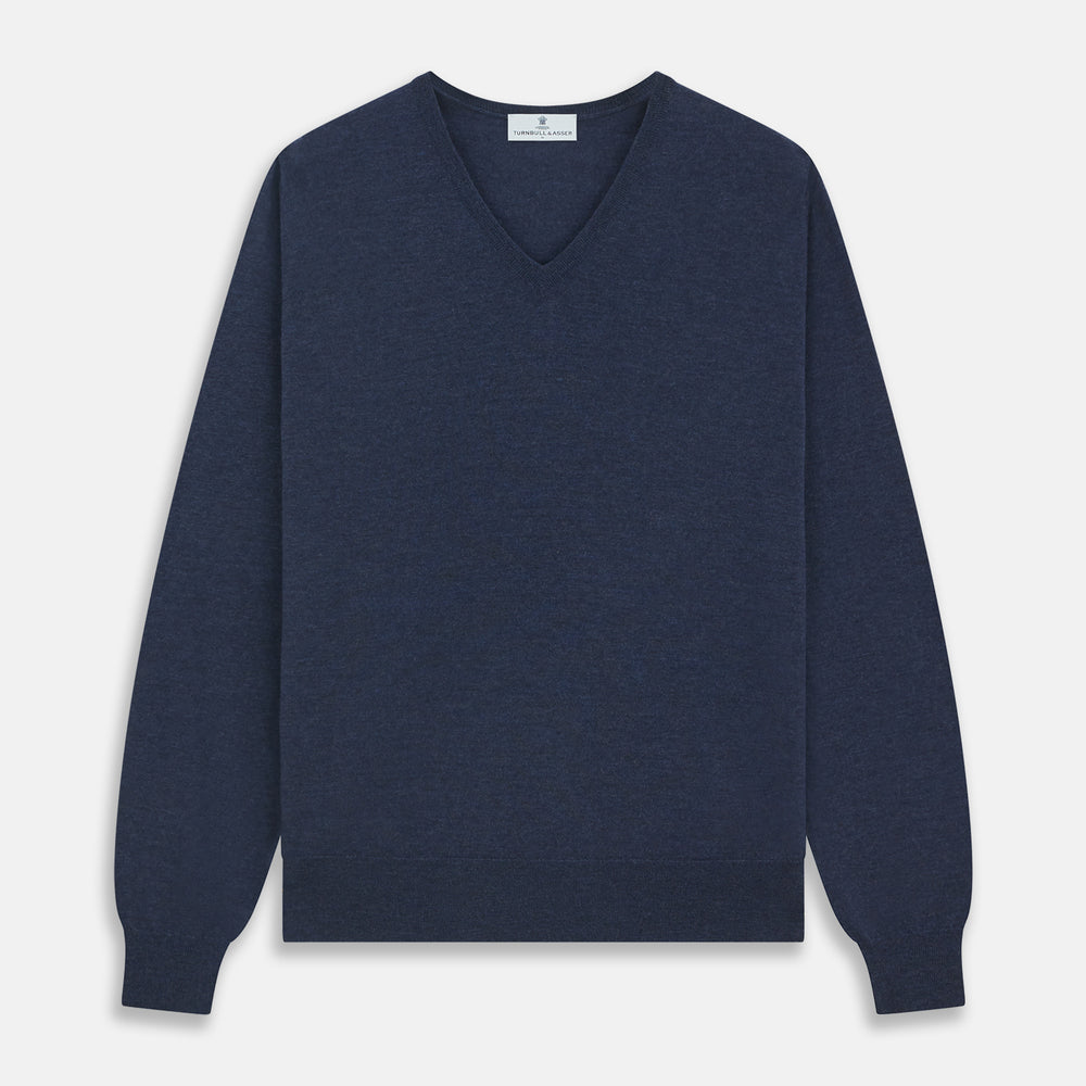 The Blue V-Neck Merino Wool Jumper by Turnbull & Asser features long sleeves, ribbed cuffs, and a ribbed hem—a timeless essential for any gentleman's wardrobe, shown laid flat on a white background.