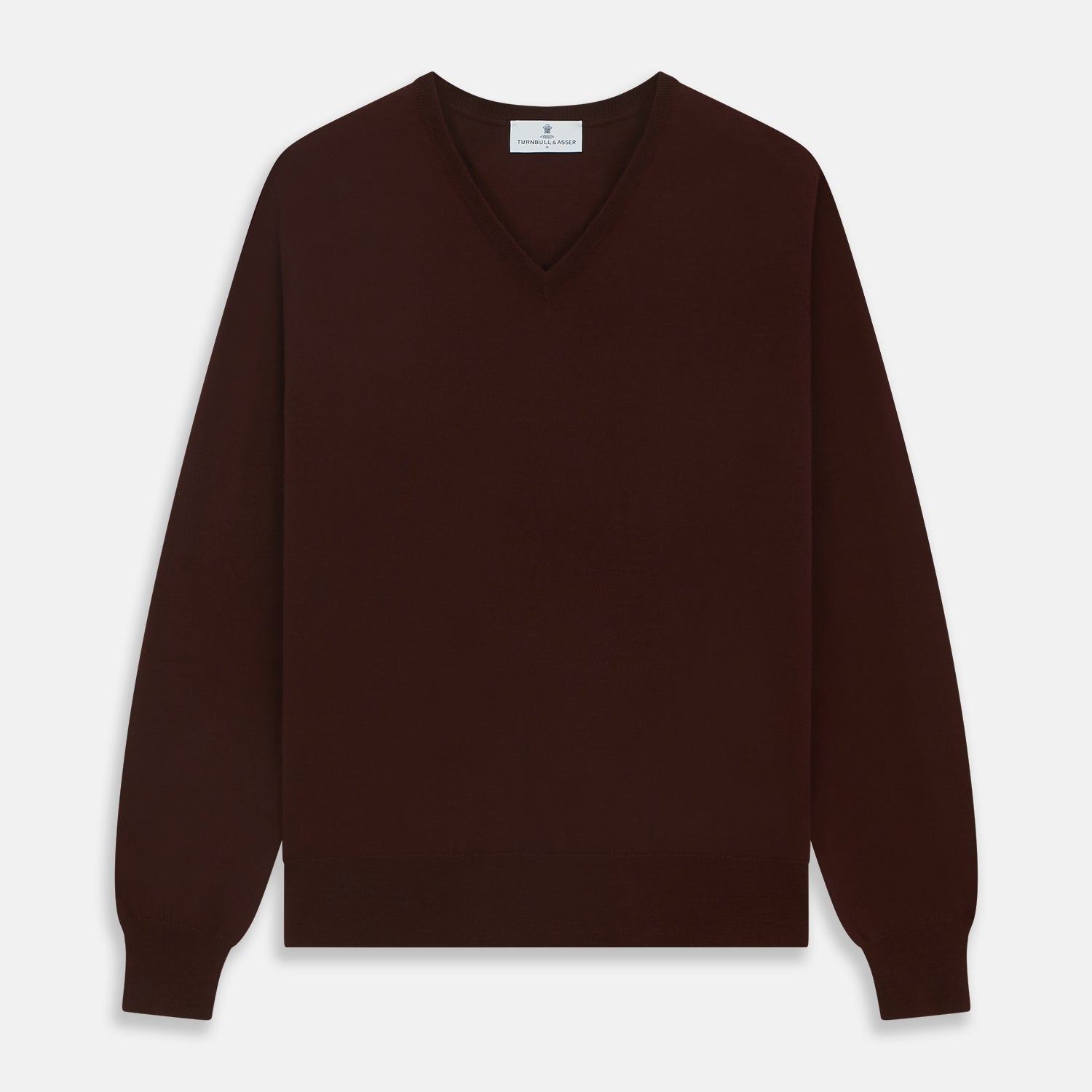 View 1 of product The Turnbull & Asser Wine V-Neck Merino Wool Jumper features long sleeves and ribbed cuffs and waistband, shown flat on a white background—a timeless staple for any gentleman’s wardrobe.