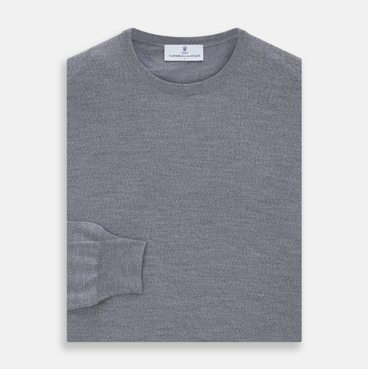 View 3 of product The Turnbull & Asser Grey Crew Neck Merino Wool Jumper, a timeless long-sleeved staple, is shown laid flat on a white background.