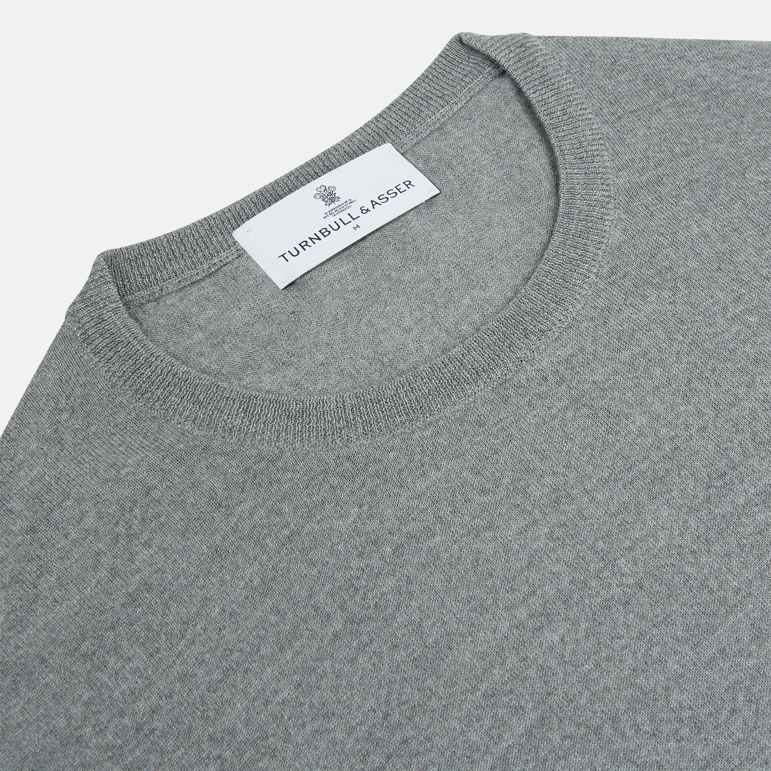 View 2 of product The Turnbull & Asser Grey Crew Neck Merino Wool Jumper, a timeless long-sleeved staple, is shown laid flat on a white background.
