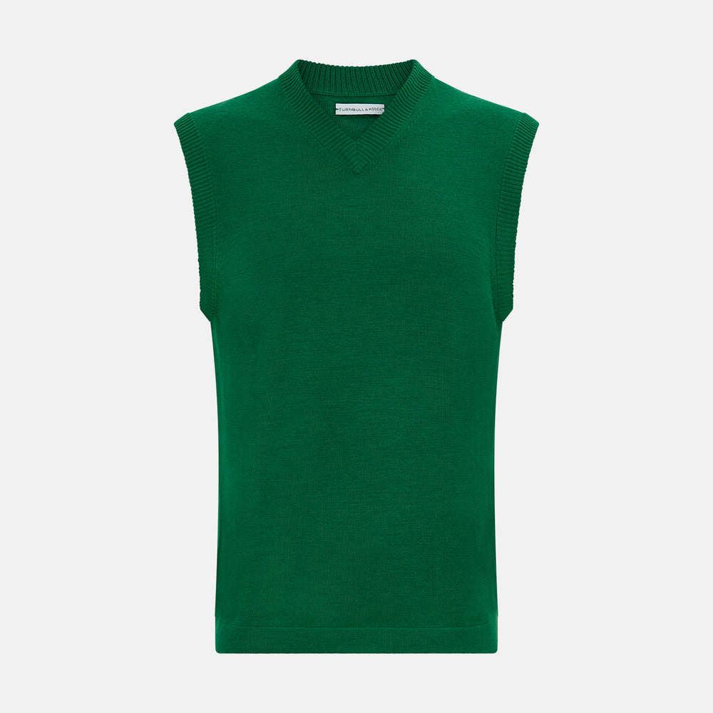 The Turnbull & Asser Hunter Green Fine Merino V-Neck Vest features a sleeveless design with ribbed edges, making it a stylish sweater vest for any gentleman. Shown against a plain white background.