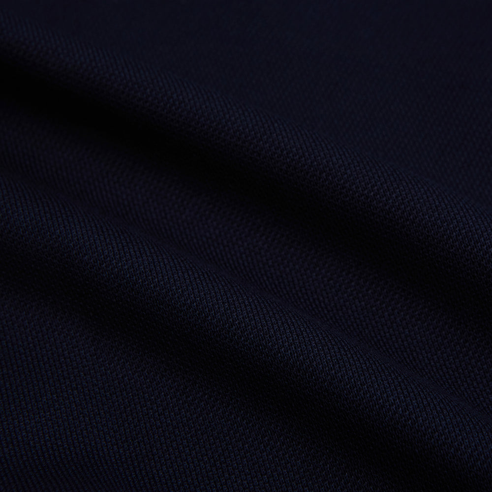 The Turnbull & Asser Navy Pique Shirt is a long-sleeved, dark navy button-up with a left chest pocket, classic collar, and buttoned cuffs, shown laid flat on a white background.