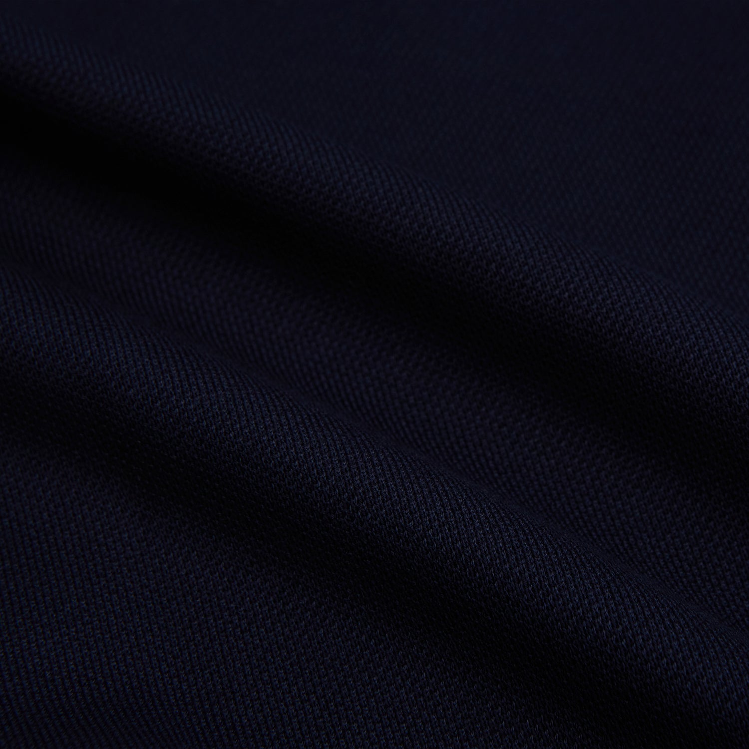 View 6 of product The Turnbull & Asser Navy Pique Shirt is a long-sleeved, dark navy button-up with a left chest pocket, classic collar, and buttoned cuffs, shown laid flat on a white background.