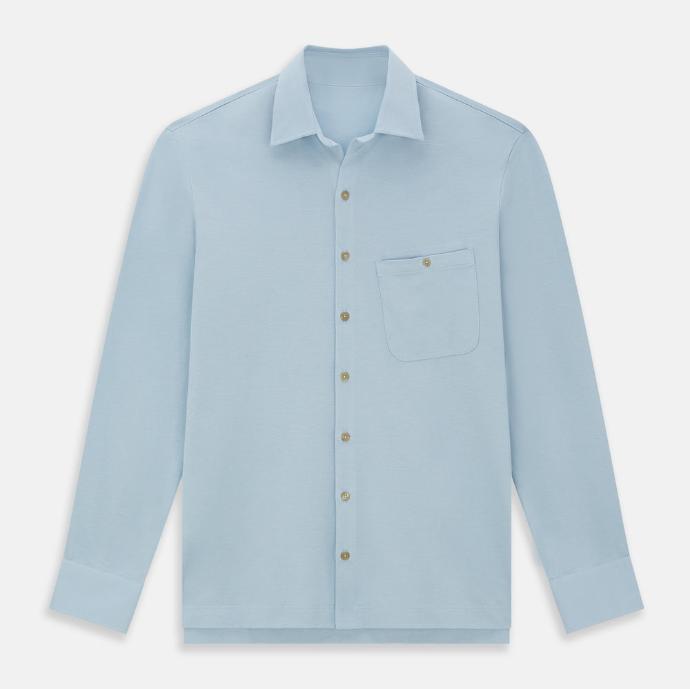 The Turnbull & Asser Pale Blue Pique Shirt is a long-sleeve button-up with an open collar, single chest pocket, and beige buttons, shown against a white background.