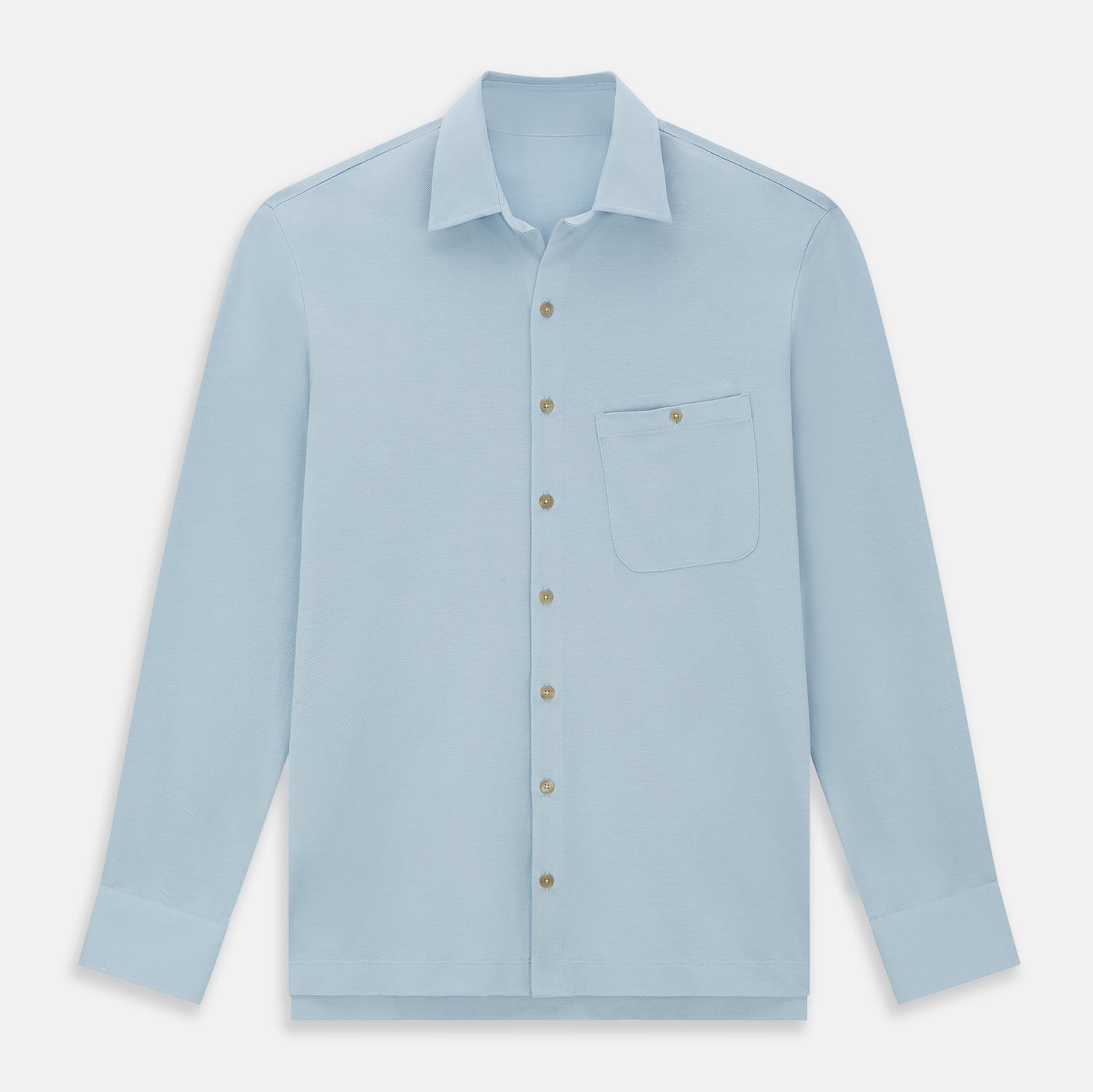 View 1 of product The Turnbull & Asser Pale Blue Pique Shirt is a long-sleeve button-up with an open collar, single chest pocket, and beige buttons, shown against a white background.