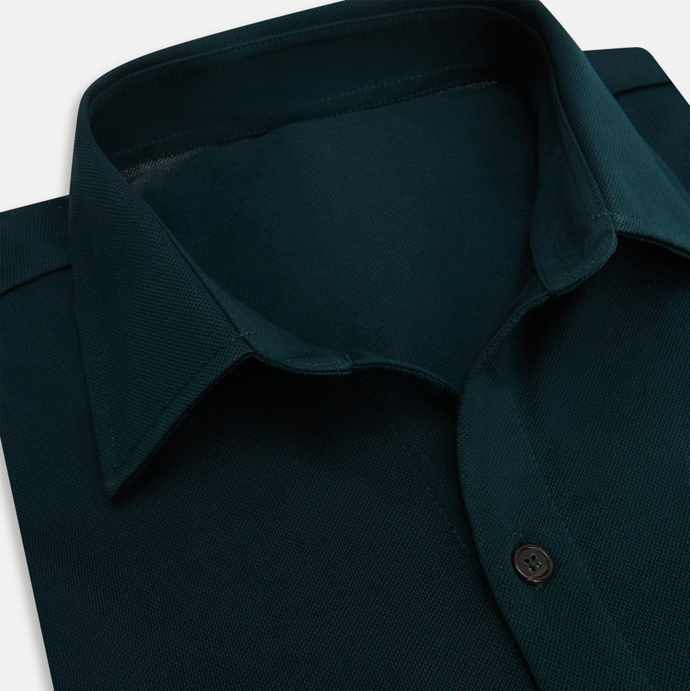 The Turnbull & Asser Dark Green Pique Shirt features long sleeves, a button-up front, chest pocket, and an elevated silhouette, displayed flat on a white background.