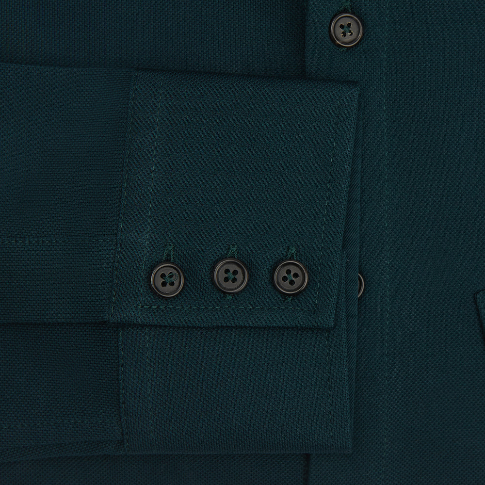 The Turnbull & Asser Dark Green Pique Shirt features long sleeves, a button-up front, chest pocket, and an elevated silhouette, displayed flat on a white background.