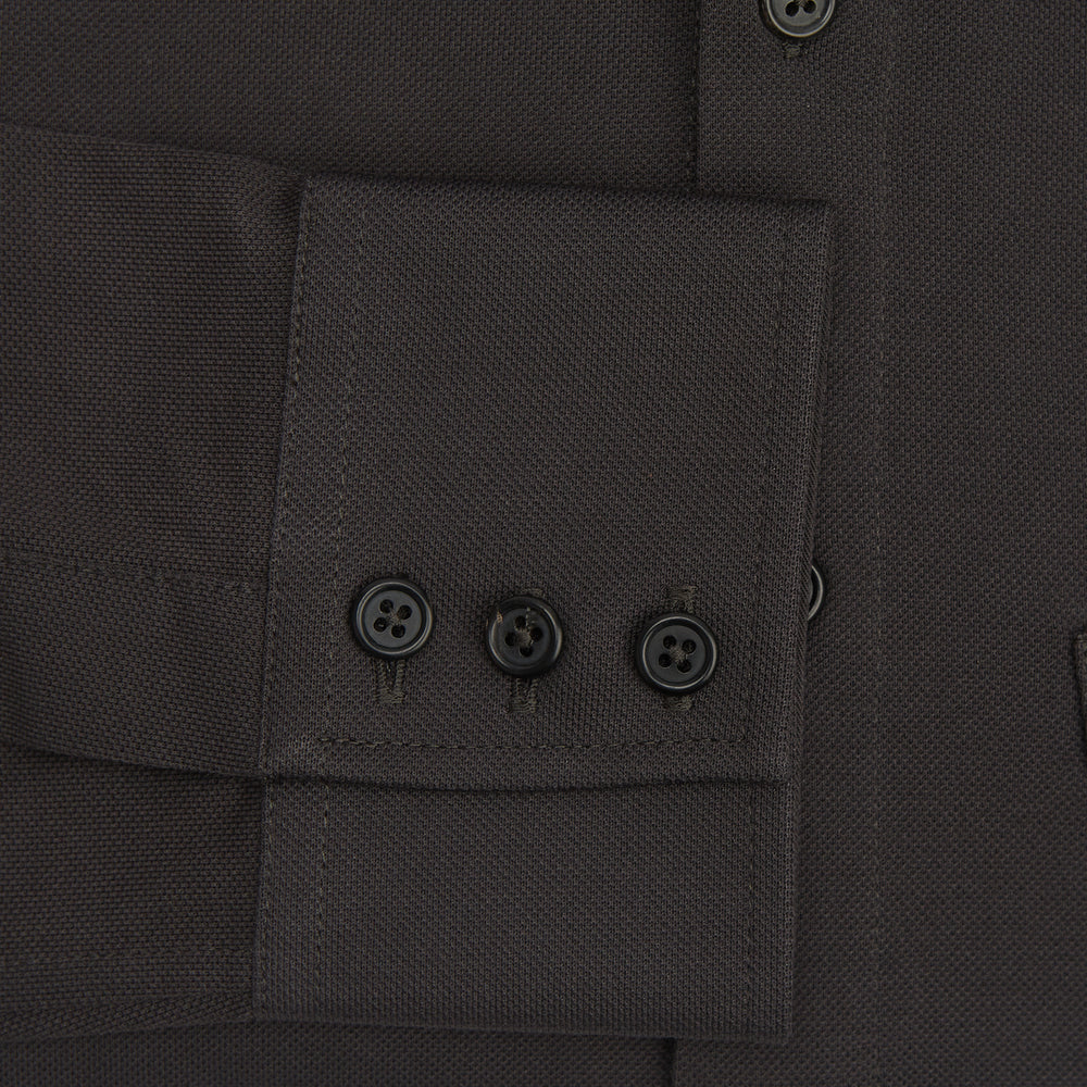 A Brown Pique Shirt by Turnbull & Asser, featuring long sleeves, a collar, and a single chest pocket, is laid flat on a white background.