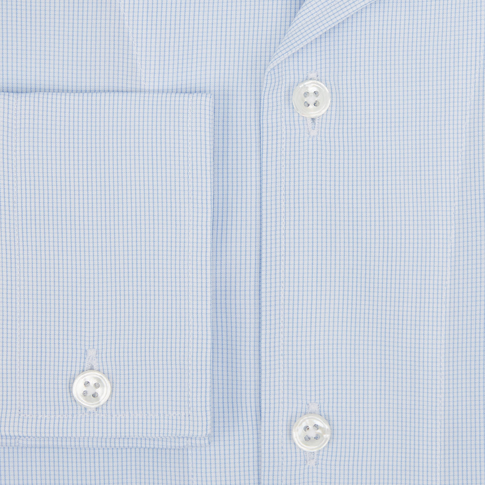 The Turnbull & Asser Pale Blue Fine Micro Check Nightshirt is a relaxed-fit, long-sleeve sleepwear piece with a collar, chest pocket, buttoned half-placket, and front pleat, shown against a plain white background.