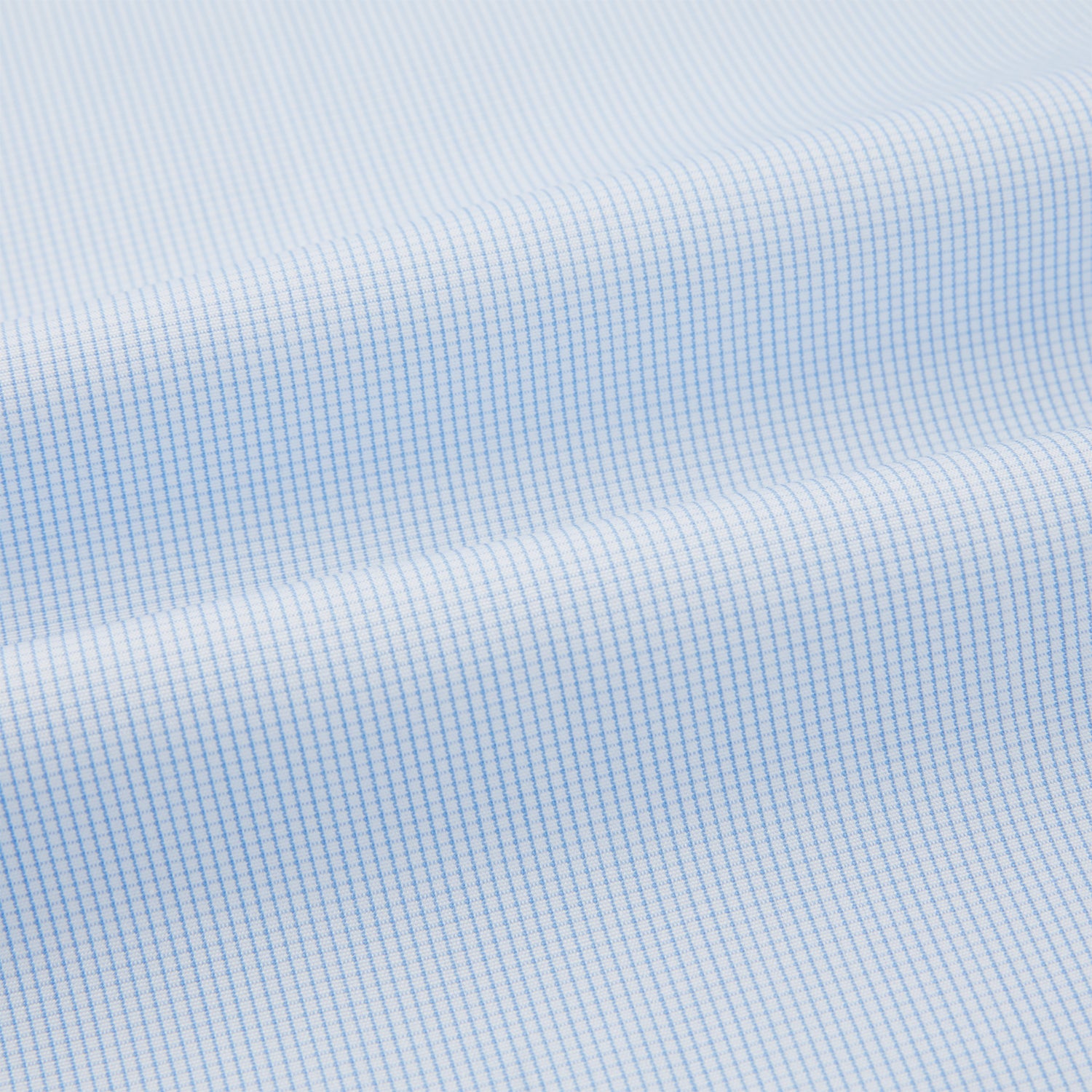 View 5 of product The Turnbull & Asser Pale Blue Fine Micro Check Nightshirt is a relaxed-fit, long-sleeve sleepwear piece with a collar, chest pocket, buttoned half-placket, and front pleat, shown against a plain white background.