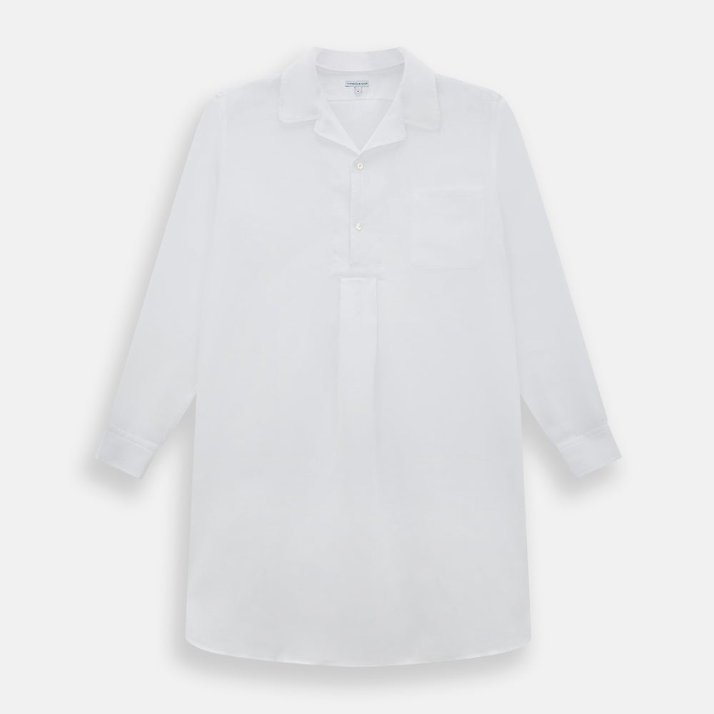 The Turnbull & Asser White Linen Nightshirt features long sleeves, a buttoned placket, single chest pocket, and relaxed fit—perfect for stylish sleepwear. Shown laid flat on a white background.