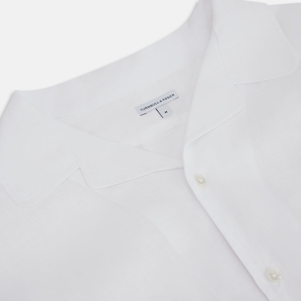 The Turnbull & Asser White Linen Nightshirt features long sleeves, a buttoned placket, single chest pocket, and relaxed fit—perfect for stylish sleepwear. Shown laid flat on a white background.