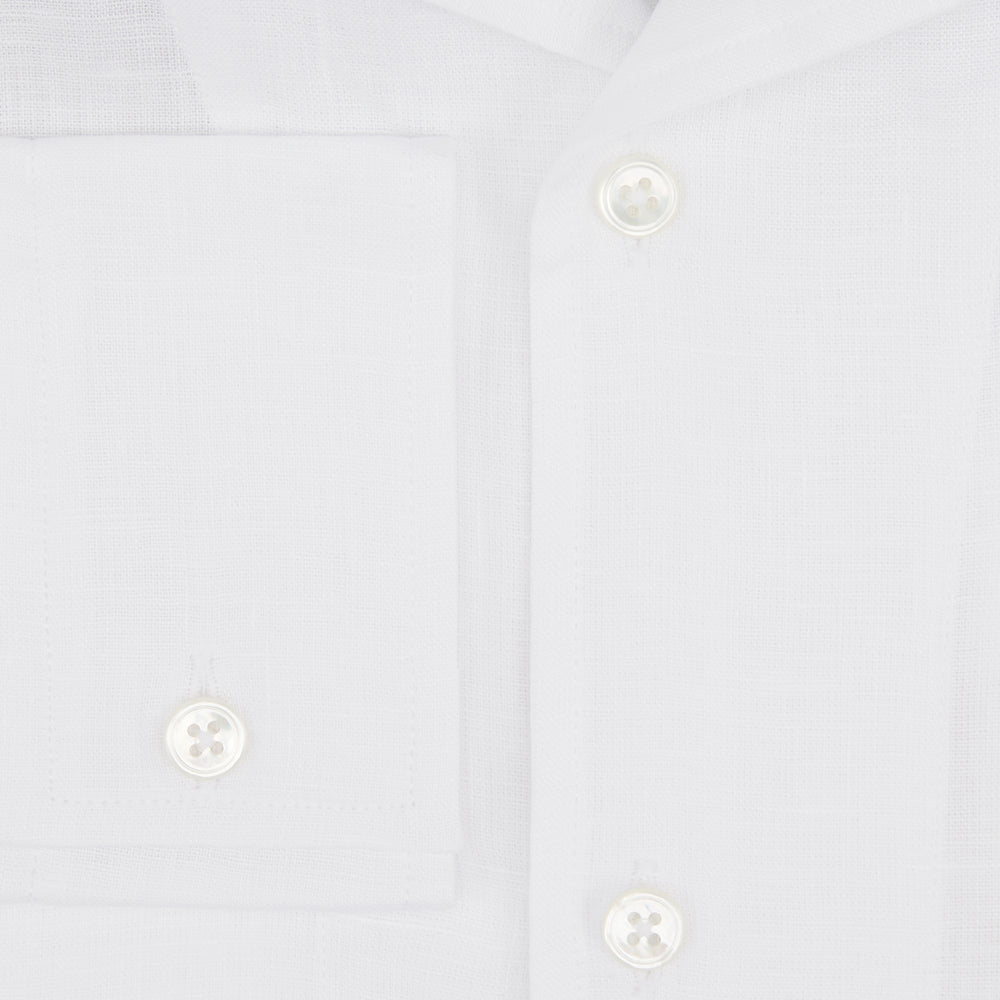 The Turnbull & Asser White Linen Nightshirt features long sleeves, a buttoned placket, single chest pocket, and relaxed fit—perfect for stylish sleepwear. Shown laid flat on a white background.