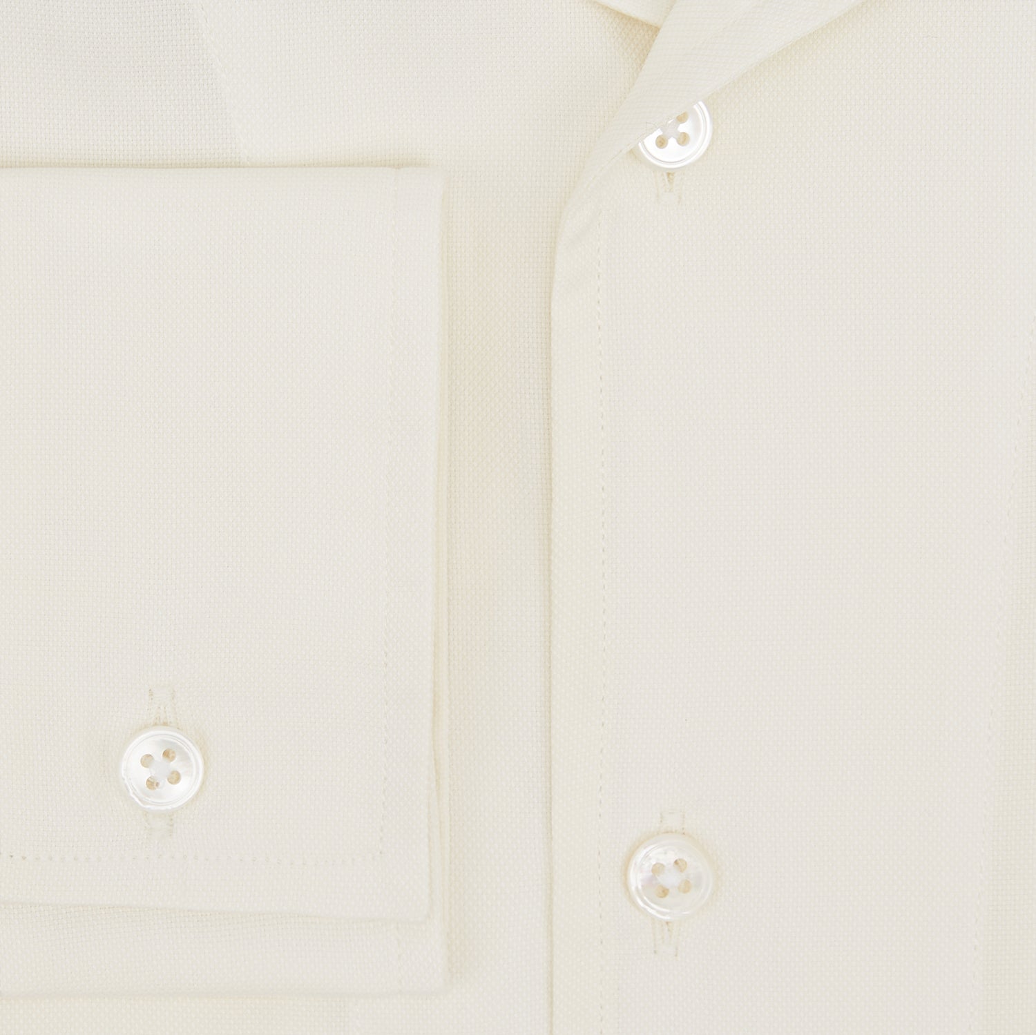 View 4 of product The Cream Nightshirt by Turnbull & Asser is a long-sleeved, cream-colored shirt dress with a collar, partial button front, chest pocket, and relaxed fit—ideal as comfortable sleepwear—shown on a plain white background.