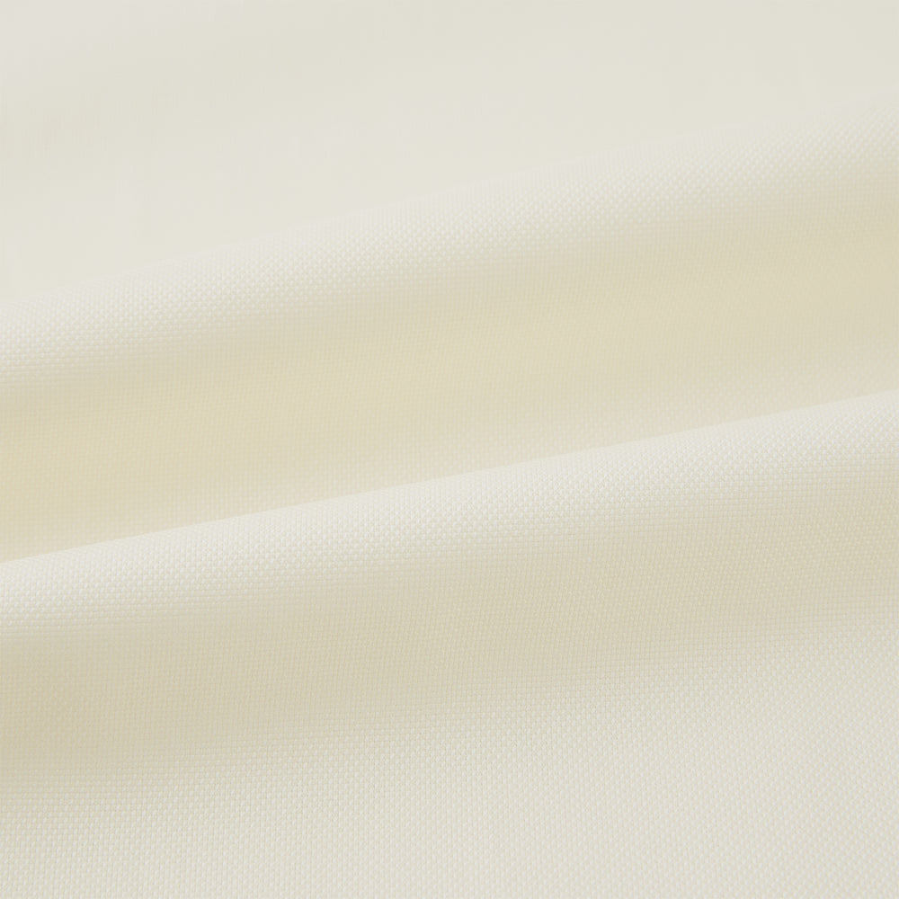 The Cream Nightshirt by Turnbull & Asser is a long-sleeved, cream-colored shirt dress with a collar, partial button front, chest pocket, and relaxed fit—ideal as comfortable sleepwear—shown on a plain white background.