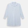 View 1 of product The Turnbull & Asser Pale Blue Bengal Stripe Nightshirt features light blue and white vertical stripes, a collar, chest pocket, and upper front buttons—perfect relaxing sleepwear, shown on a white background.