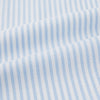 View 5 of product The Turnbull & Asser Pale Blue Bengal Stripe Nightshirt features light blue and white vertical stripes, a collar, chest pocket, and upper front buttons—perfect relaxing sleepwear, shown on a white background.