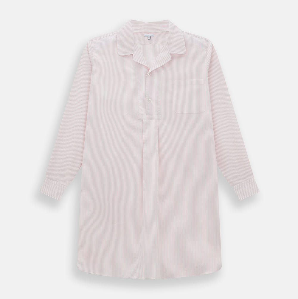 The Turnbull & Asser Pale Pink Bengal Stripe Nightshirt features long sleeves, a subtle striped pattern, a collar, chest pocket, and front buttons. Shown flat on a white background, this stylish sleepwear offers comfort and elegance.