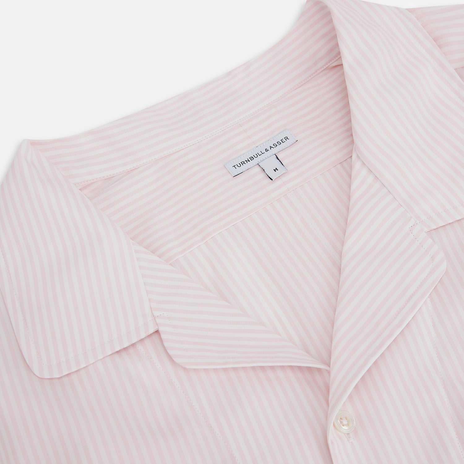View 2 of product The Turnbull & Asser Pale Pink Bengal Stripe Nightshirt features long sleeves, a subtle striped pattern, a collar, chest pocket, and front buttons. Shown flat on a white background, this stylish sleepwear offers comfort and elegance.