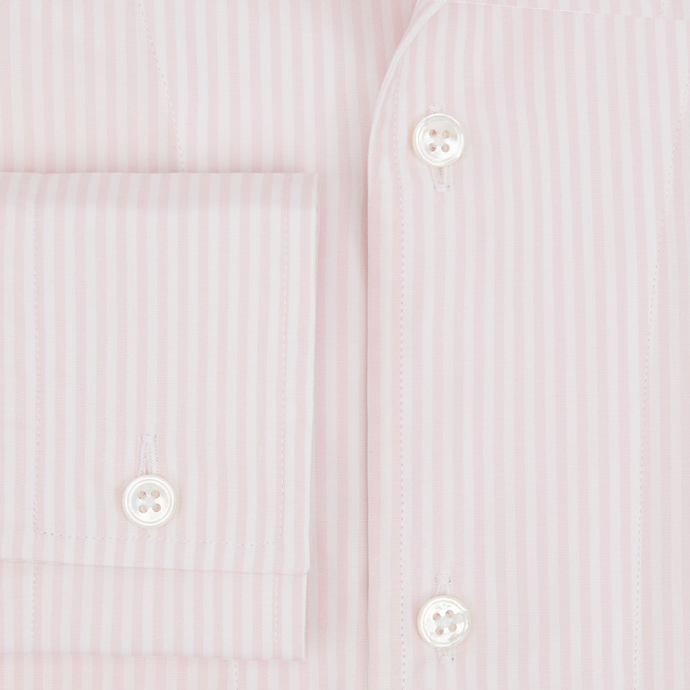 The Turnbull & Asser Pale Pink Bengal Stripe Nightshirt features long sleeves, a subtle striped pattern, a collar, chest pocket, and front buttons. Shown flat on a white background, this stylish sleepwear offers comfort and elegance.