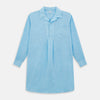 View 1 of product The Turnbull & Asser Turquoise Linen Nightshirt features long sleeves, a collar, button placket, single chest pocket, and a loose fit. Shown in light blue on a plain white background.