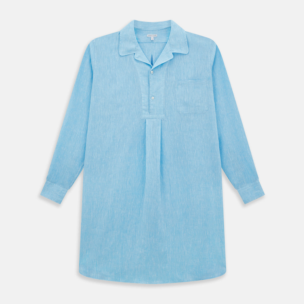 The Turnbull & Asser Turquoise Linen Nightshirt features long sleeves, a collar, button placket, single chest pocket, and a loose fit. Shown in light blue on a plain white background.