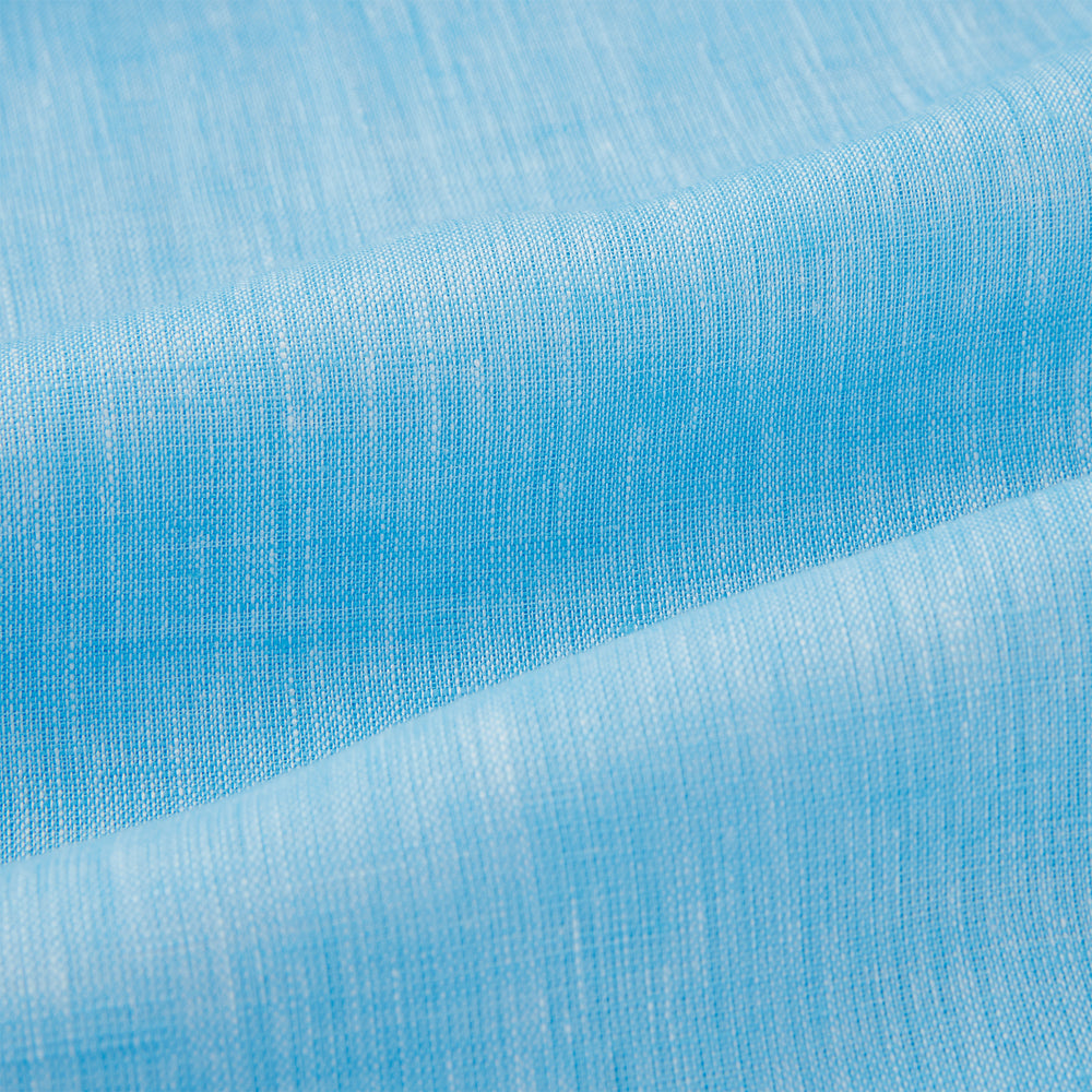 The Turnbull & Asser Turquoise Linen Nightshirt features long sleeves, a collar, button placket, single chest pocket, and a loose fit. Shown in light blue on a plain white background.